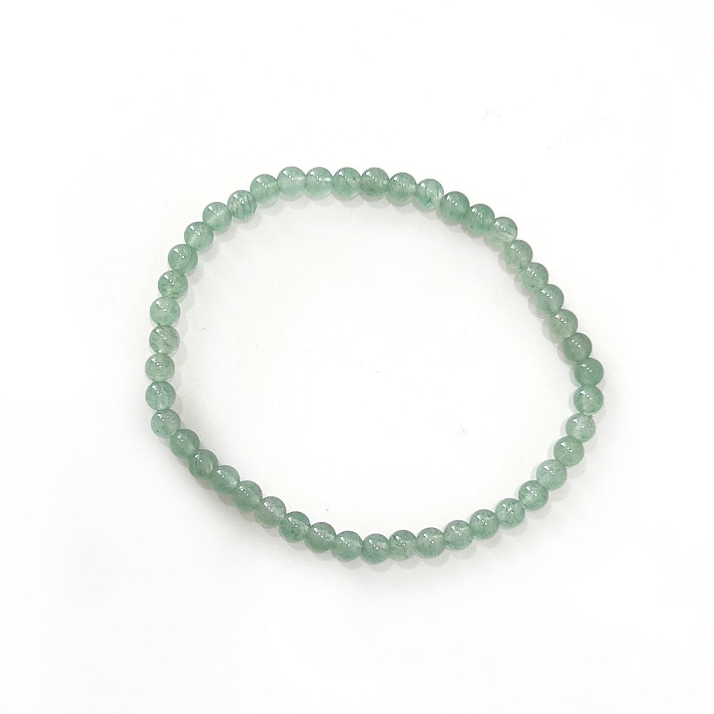 A bracelet made of small, 4mm green aventurine beads, showcasing a translucent green hue with natural variations. The beads are strung closely together, forming a continuous loop against a white background, reflecting the stone's reputation for bringing luck and prosperity.