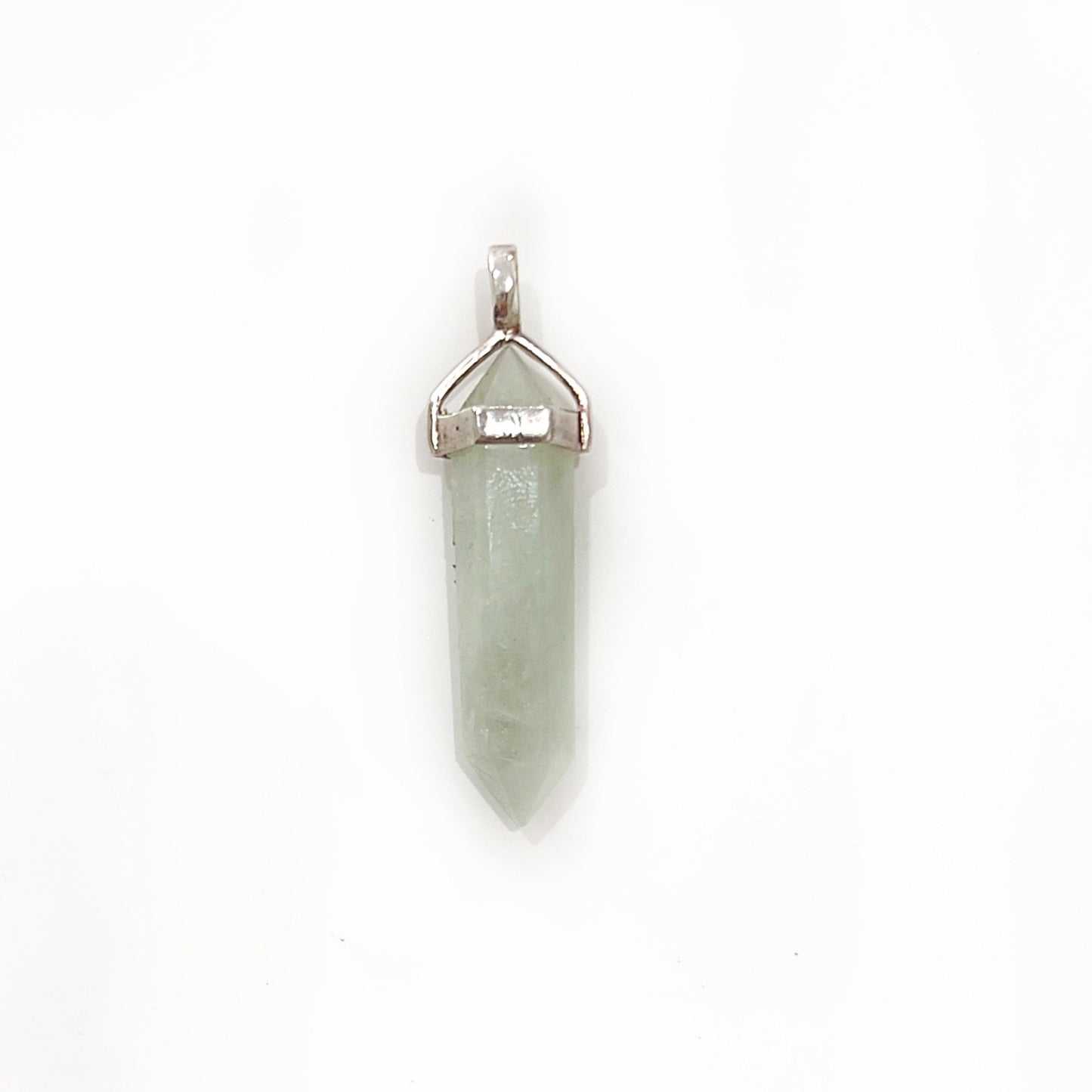 A delicate sterling silver jade pendant featuring a slender, polished green jade stone set in a simple yet elegant silver cap and bail. The jade exhibits subtle variations in tone, highlighting its natural beauty and smooth finish. | Simply Esoteric