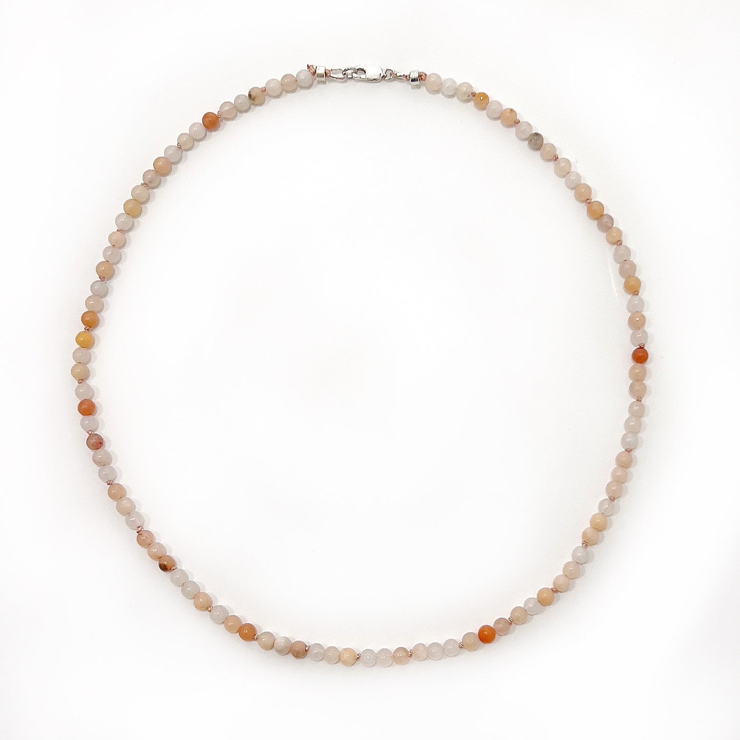 A delicate pink aventurine bead necklace with 6mm beads, pearl-knotted on silk thread, approximately 45cm in length, featuring a sterling silver clasp, embodying elegance and positive energy. | Simply Esoteric
