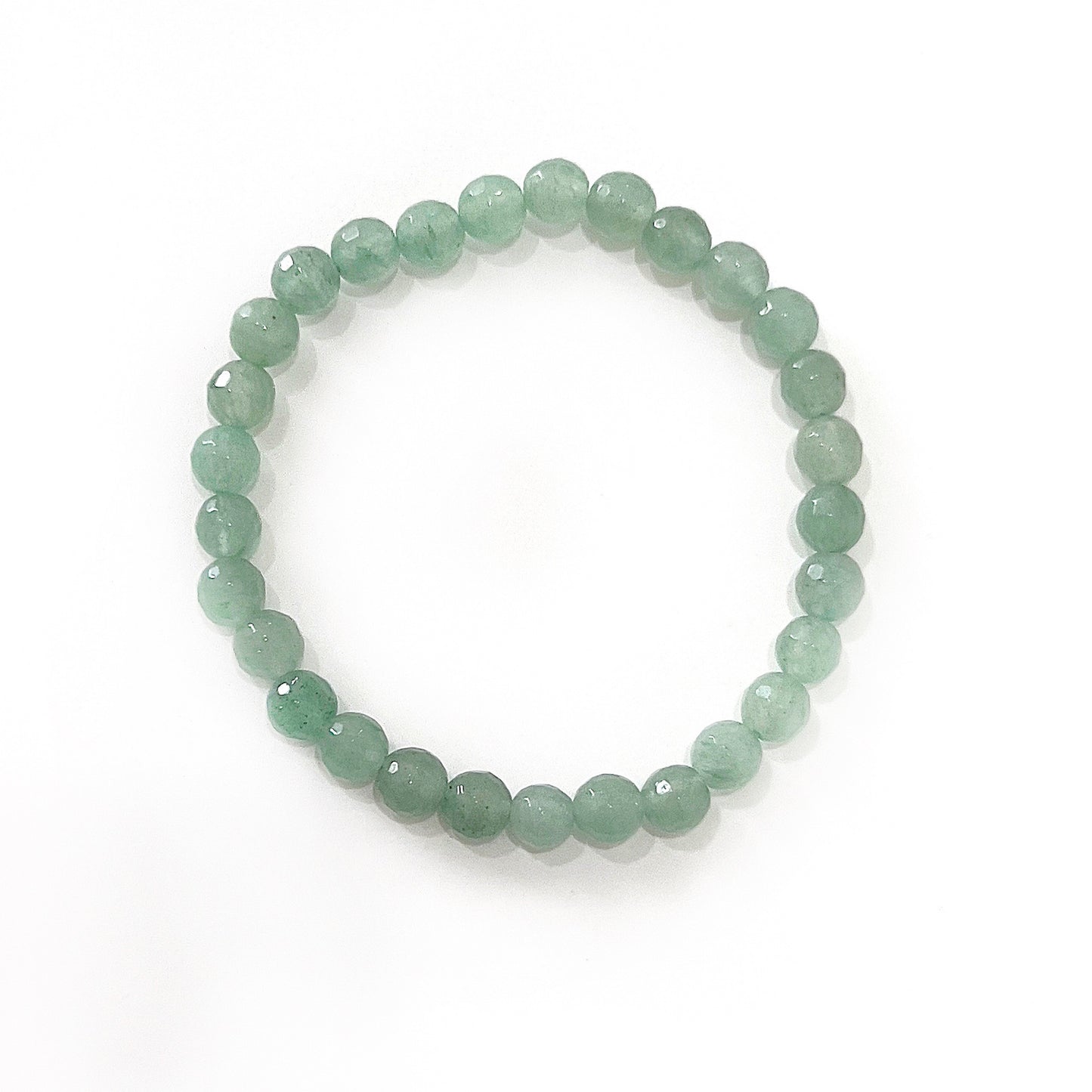 A faceted green aventurine bead bracelet composed of 6mm beads with a polished finish, displaying a spectrum of light to medium green shades. The bracelet is elegantly crafted, forming a full circle and laid out against a clean white background, highlighting the gemstone's natural sparkle and vitality. | Simply Esoteric