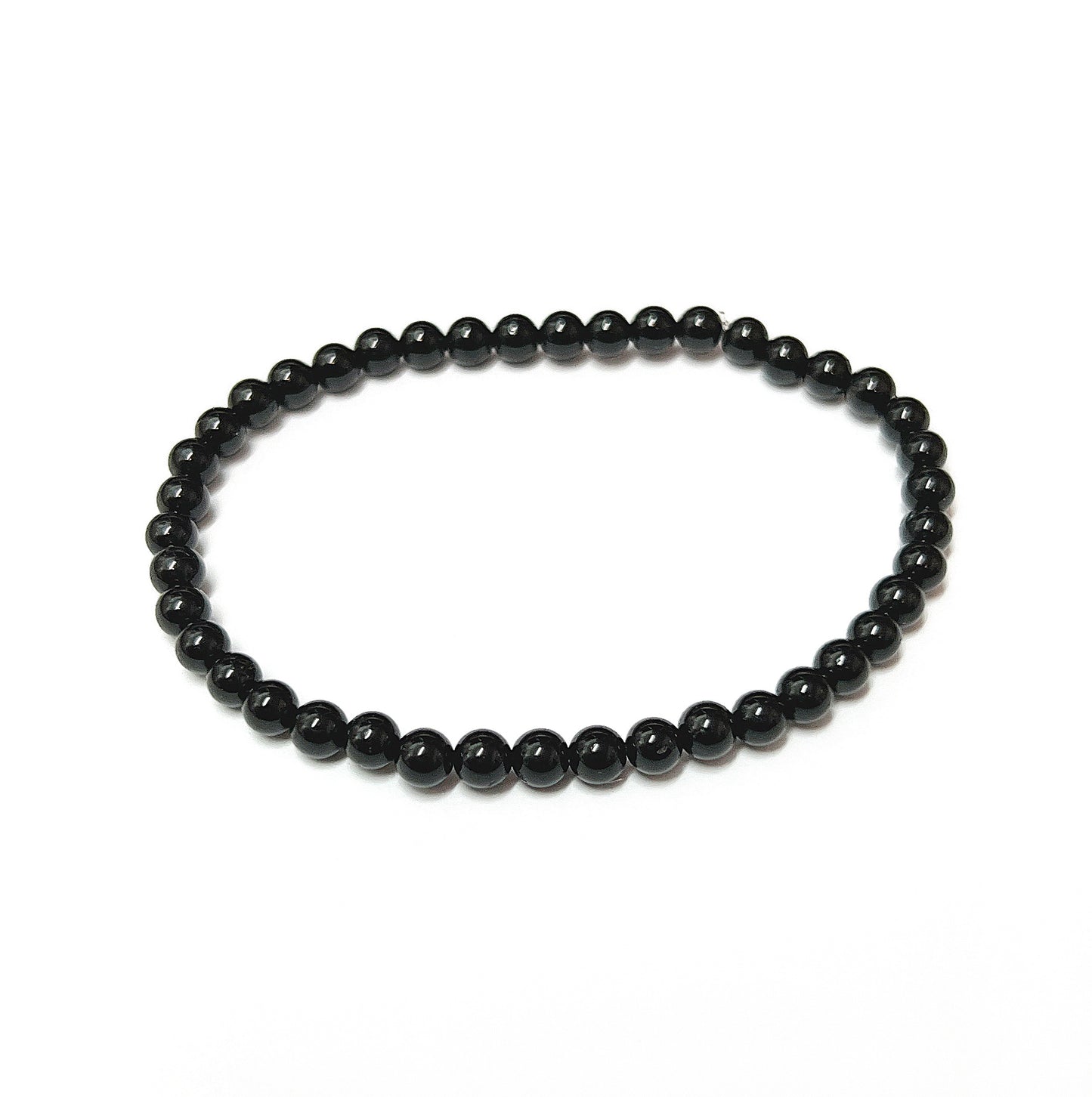 A sleek black tourmaline bead bracelet with uniform 4mm beads, known for protective qualities, on an 18cm stretch cord for a comfortable fit and easy daily wear. | Simply Esoteric