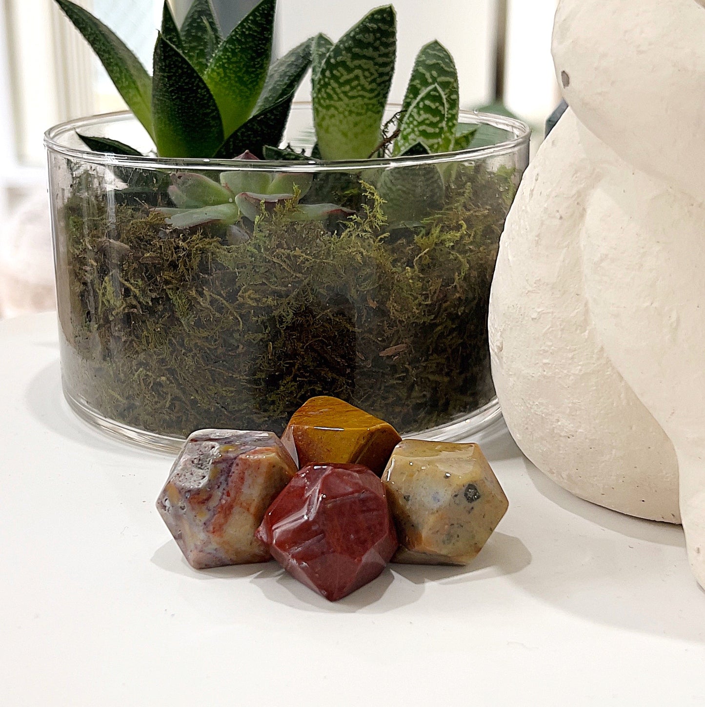 Ocean Jasper Dodecahedrons approximately 2-2.5cm in size, showcasing intricate patterns and vibrant colors ranging from greens and blues to yellows and pinks, displayed on a light background. | Simply Esoteric