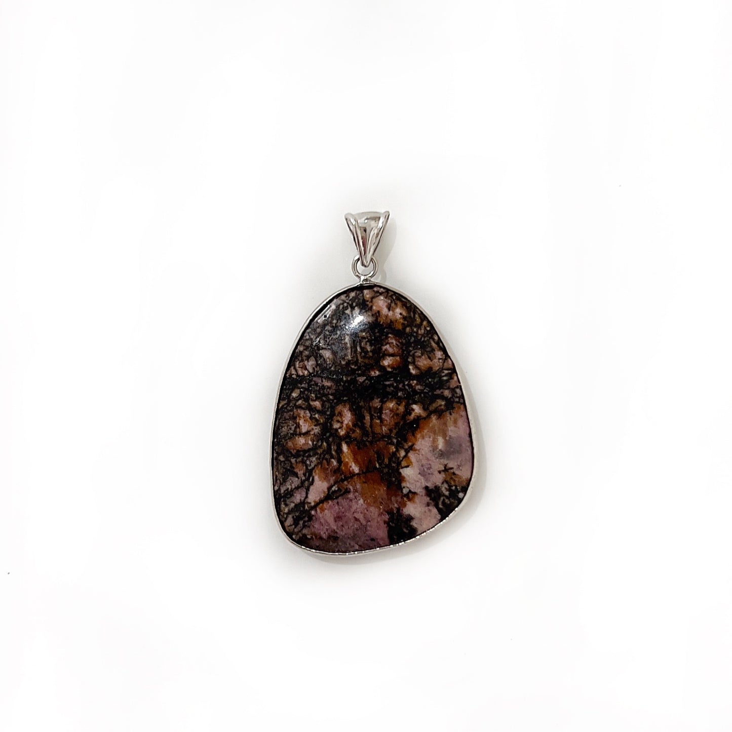 An exquisite silver-colored rhodonite pendant, with the stone's surface featuring a dynamic pattern of dark pink and black veins. The gemstone is cut into a smooth, teardrop shape and set in a sleek silver mount that accentuates its natural beauty, displayed against a bright white background. | Simply Esoteric
