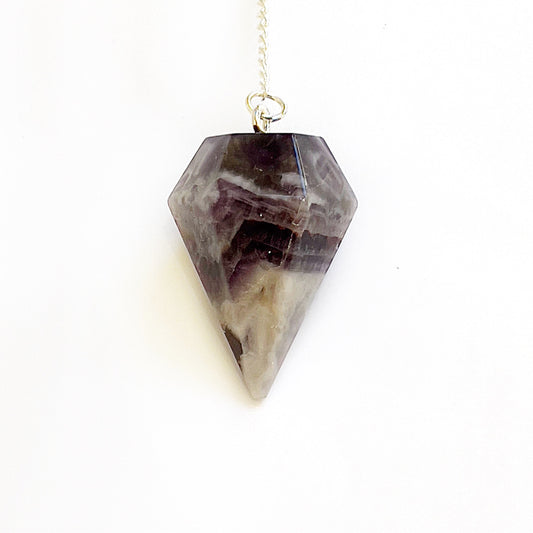 A Chevron Amethyst pendulum with distinctive V-shaped patterns, suspended on a durable chain, symbolizing spiritual intuition and guidance. | Simply Esoteric