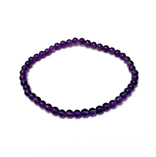 A vibrant A-grade Amethyst bead bracelet with rich purple 4mm beads, strung neatly on an 18cm stretch cord, designed to provide both beauty and spiritual benefits. | Simply Esoteric