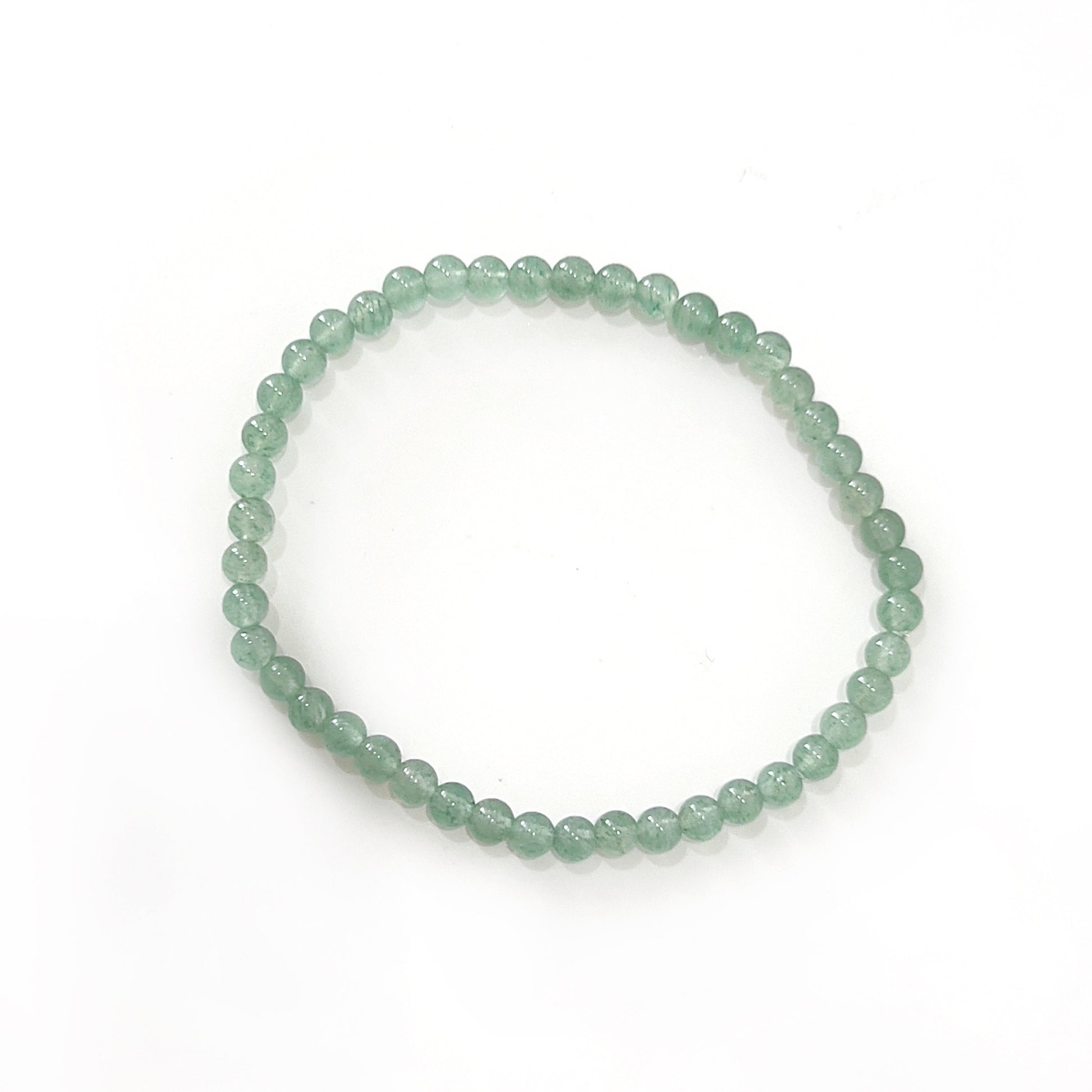 A bracelet made of small, 4mm green aventurine beads, showcasing a translucent green hue with natural variations. The beads are strung closely together, forming a continuous loop against a white background, reflecting the stone's reputation for bringing luck and prosperity.