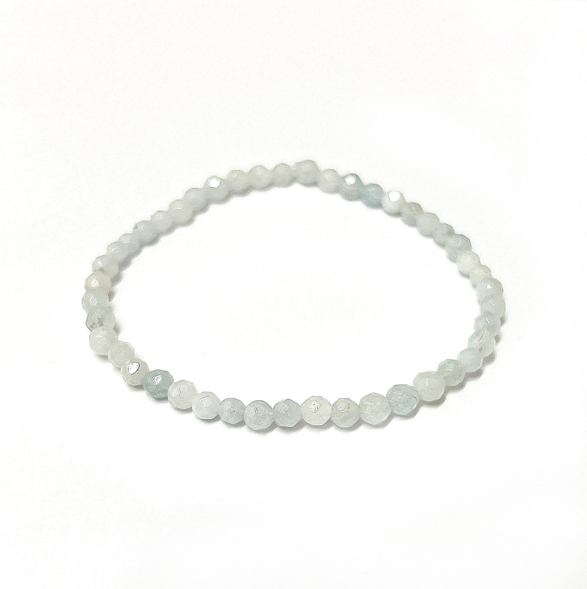 An elegant aquamarine bead bracelet with 4mm faceted beads showcasing shades of tranquil sea blue, strung on an 18cm stretchy cord, embodying the calming essence of the ocean. | Simply Esoteric