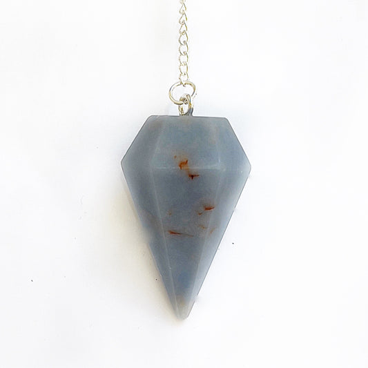 An Angelite pendulum with a soft blue hue, symbolizing tranquility and spiritual communication, hanging from a delicate chain, inviting guidance and angelic protection. | Simply Esoteric