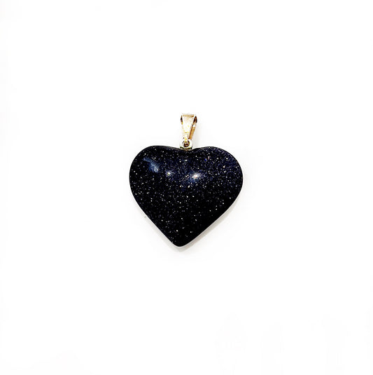 A Blue Goldstone heart-shaped pendant, characterized by its deep midnight blue color sprinkled with subtle glittery specks that resemble stars in the night sky, attached to a simple golden bail suitable for wearing on a chain. | Simply Esoteric