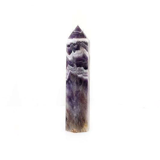 A Chevron Amethyst tower featuring distinct V-shaped patterns in shades of deep purple and white, polished to a point that enhances its natural, striking banding. This crystal tower is ideal for promoting spiritual growth and psychic intuition. | Simply Esoteric