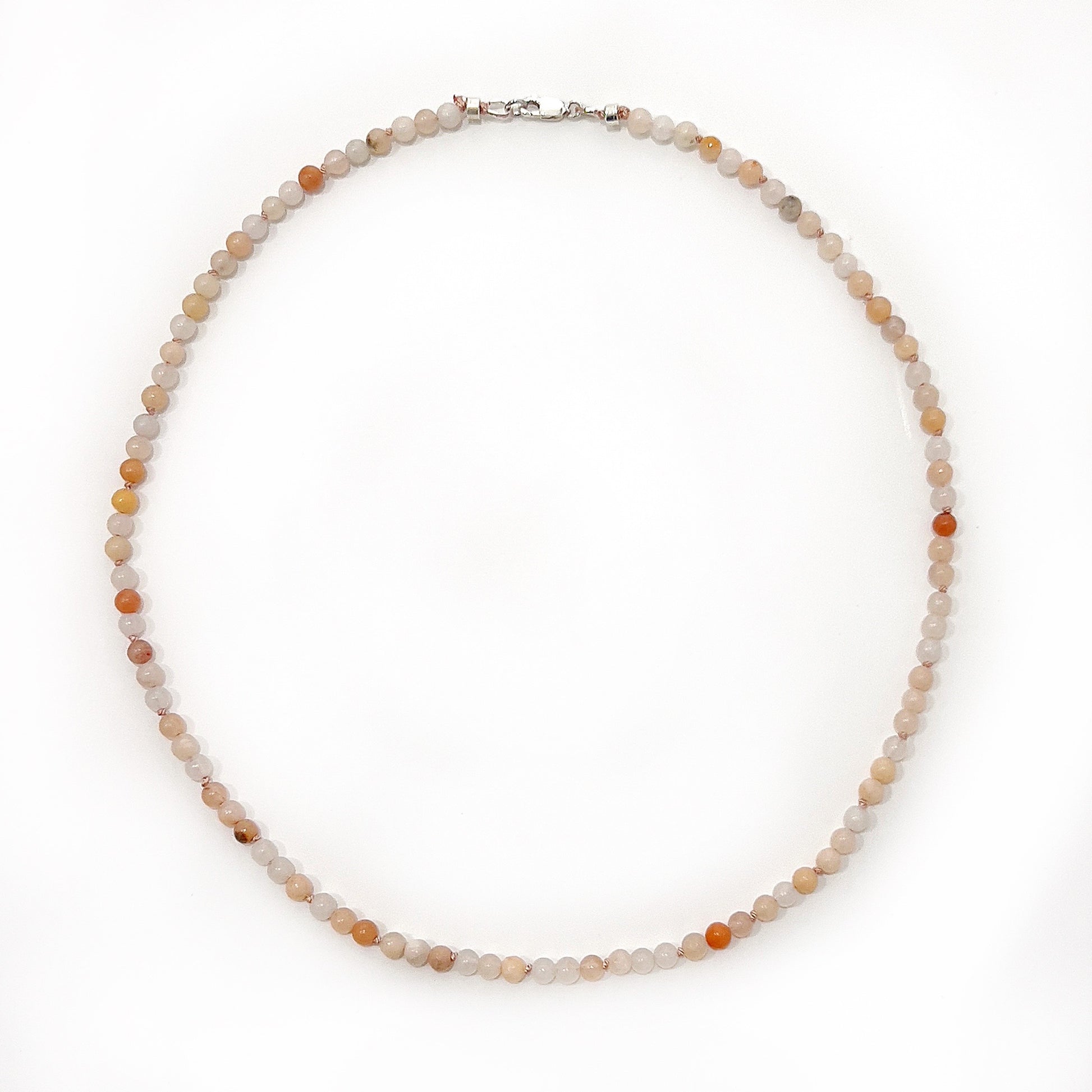 A delicate pink aventurine bead necklace with 6mm beads, pearl-knotted on silk thread, approximately 45cm in length, featuring a sterling silver clasp, embodying elegance and positive energy. | Simply Esoteric