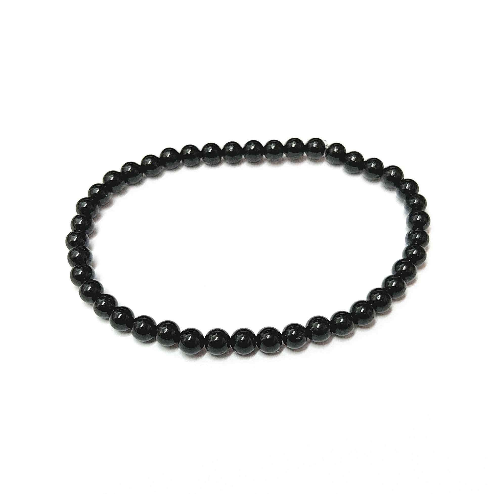 A sleek black tourmaline bead bracelet with uniform 4mm beads, known for protective qualities, on an 18cm stretch cord for a comfortable fit and easy daily wear. | Simply Esoteric