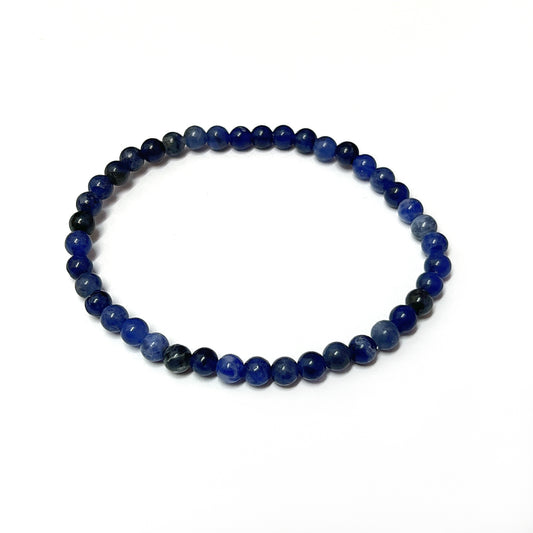 A Sodalite bead bracelet with rich royal blue 4mm beads interlaced with white patterns, strung on an 18cm stretch cord, capturing the essence of a starry night sky. | Simply Esoteric