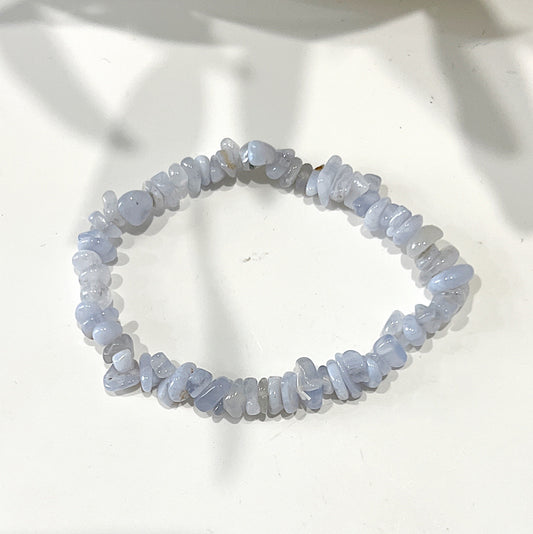 A Blue Lace Agate chip bracelet on a stretchy cord, showcasing light blue stones with subtle white banding, arranged in an organic and natural formation. The bracelet is displayed on a white background. | Simply Esoteric