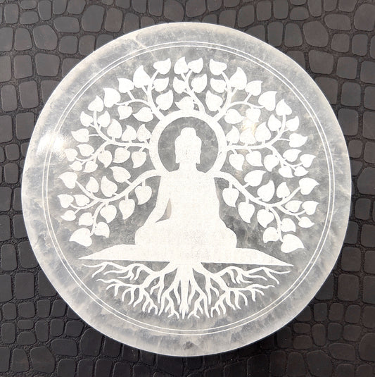 A polished selenite charging plate with a smooth, oval shape and a pearly white glow. Known for its energy-cleansing properties, the plate has a flat surface ideal for placing other crystals upon for purification and recharging, highlighted against a simple background that accentuates its pure, clean appearance. | Simply Esoteric