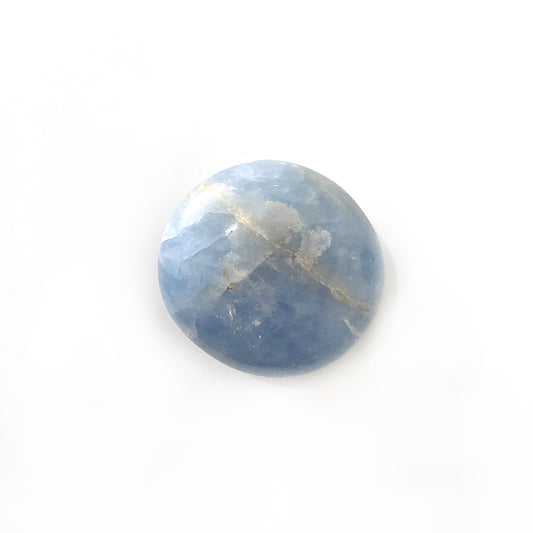 A smooth and soothing blue calcite palm stone, with gentle sky-blue tones and subtle natural banding, comfortably fitting in the curve of the hand for a calming presence. | Simply Esoteric